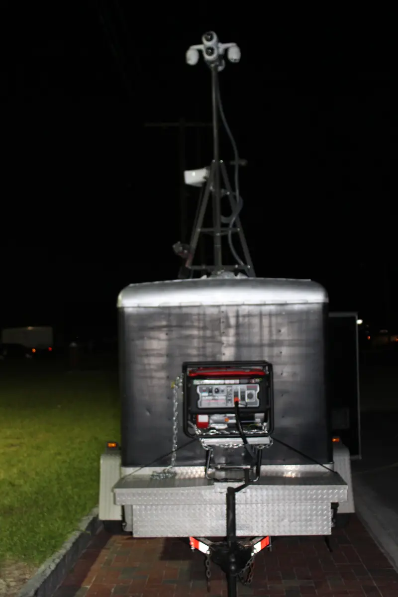 Front profile of the Mobile GuardShack showing hitch, generator platform, aluminum storage and telescoping camera mast