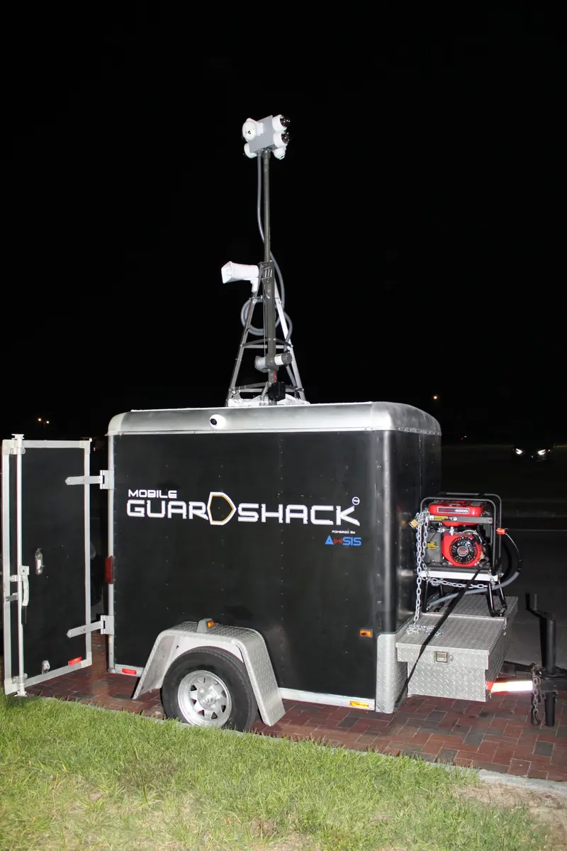 Real Mobile GuardShack black trailer with mast, roof horn, exterior generator and diamond-plate storage boxes